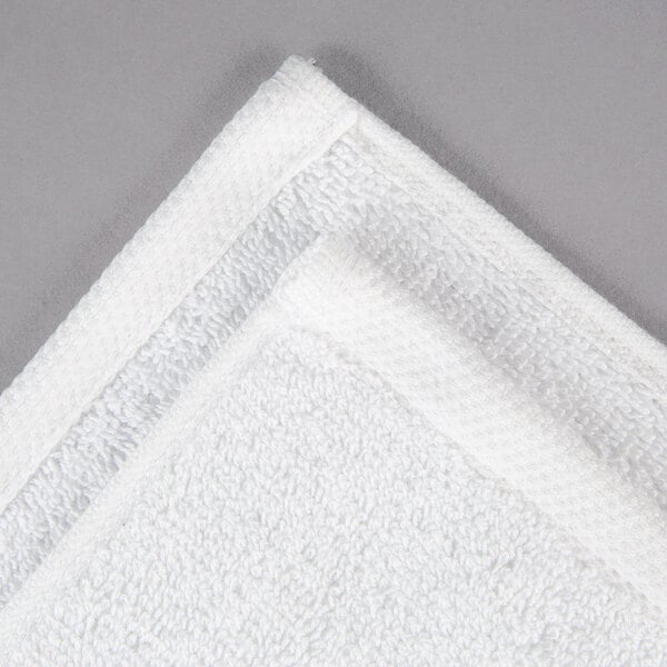 A white Oxford Platinum wash cloth with a white dobby twill border.