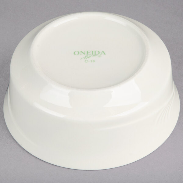 A white Oneida china bowl with green Espree text on it.