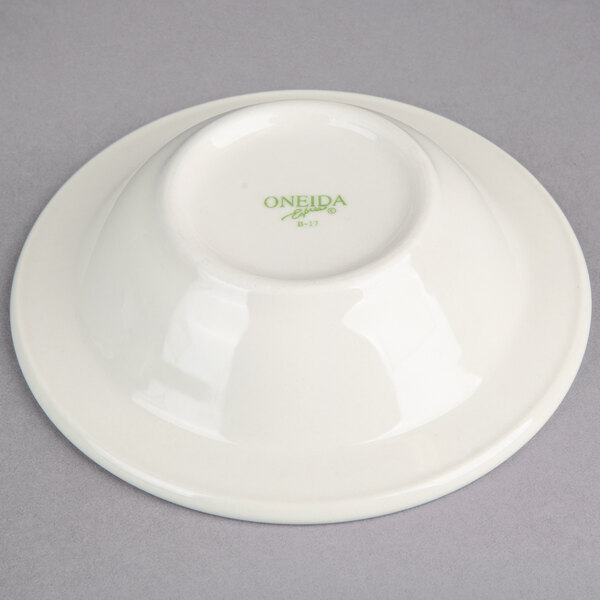 A white Oneida china fruit bowl with a green logo.