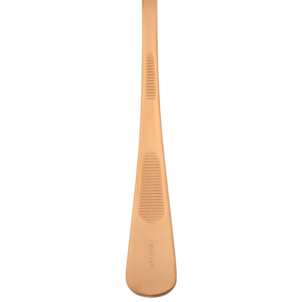 A Mercer Culinary rose gold plating spoon with a white background.