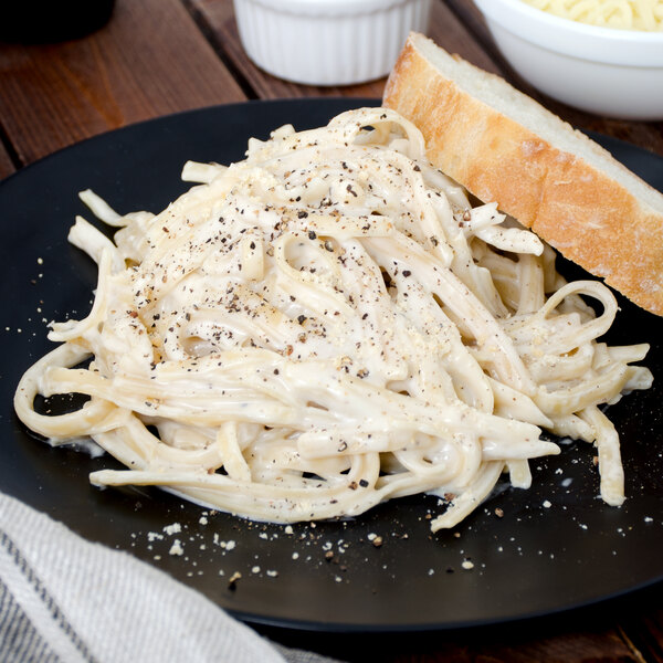 A plate of Napoli linguine pasta with bread.