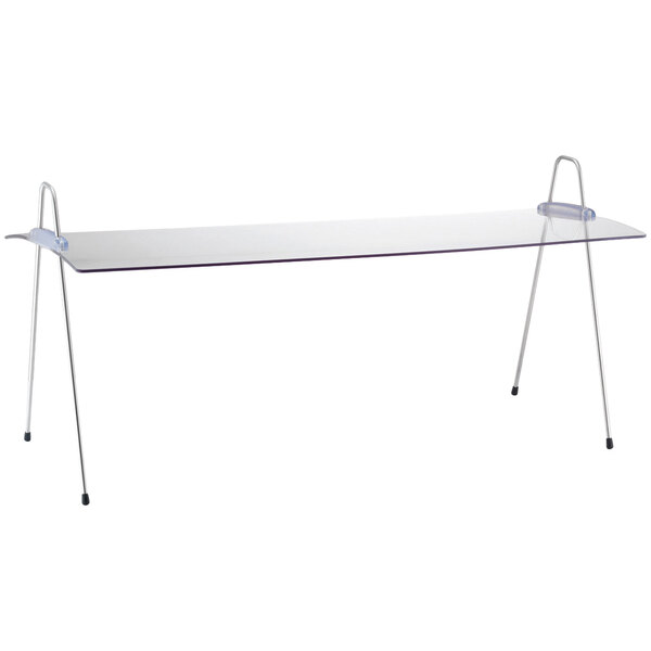 A white rectangular Frilich acrylic sneeze guard with a black border on a long rectangular table.