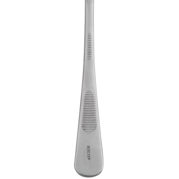 A close-up of a Mercer Culinary stainless steel plating spoon.