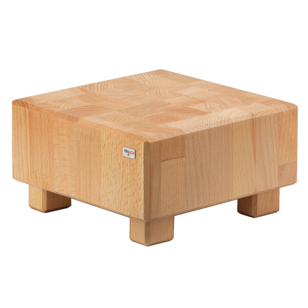 A Frilich beech wood butcher block cube riser with legs.