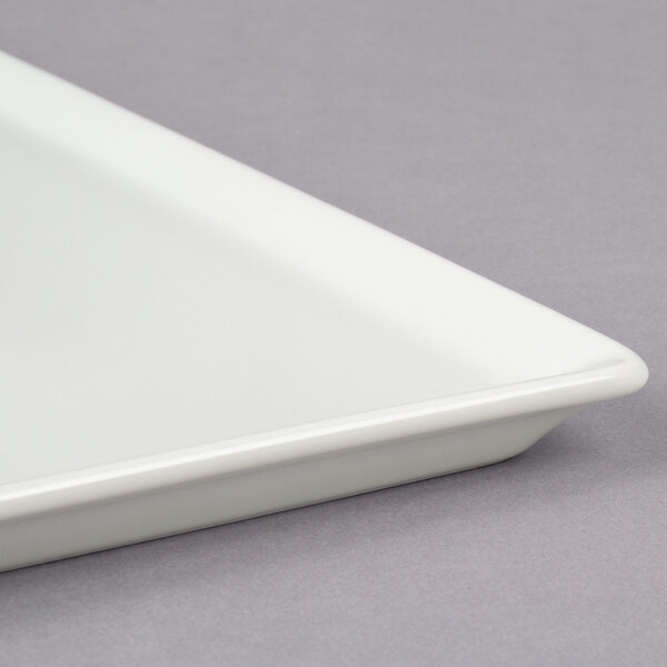 A white square Frilich china display plate.