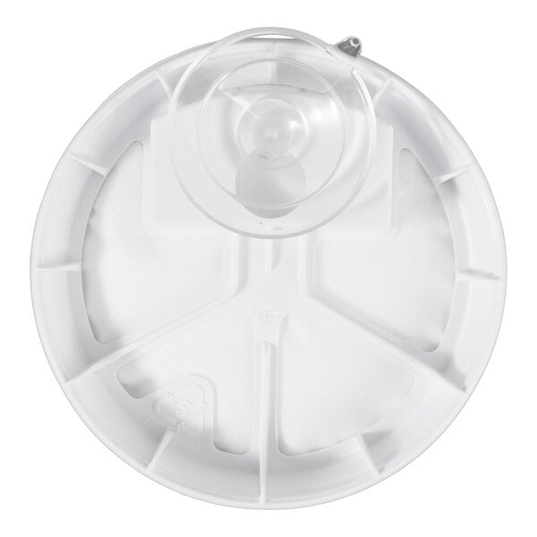 A round, white plastic object with a central raised section and several compartment-like divisions, viewed from above.