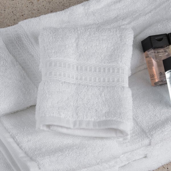 A white Oxford Reserve washcloth with a bottle of liquid on it.