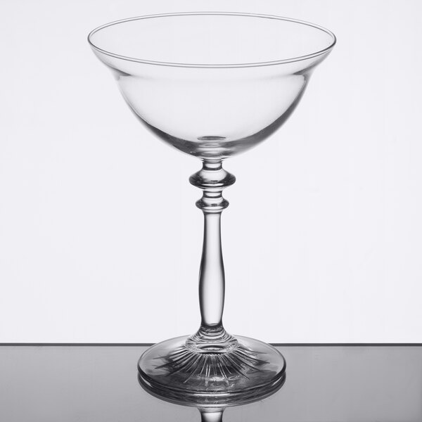 A clear Libbey coupe cocktail glass with a stem.