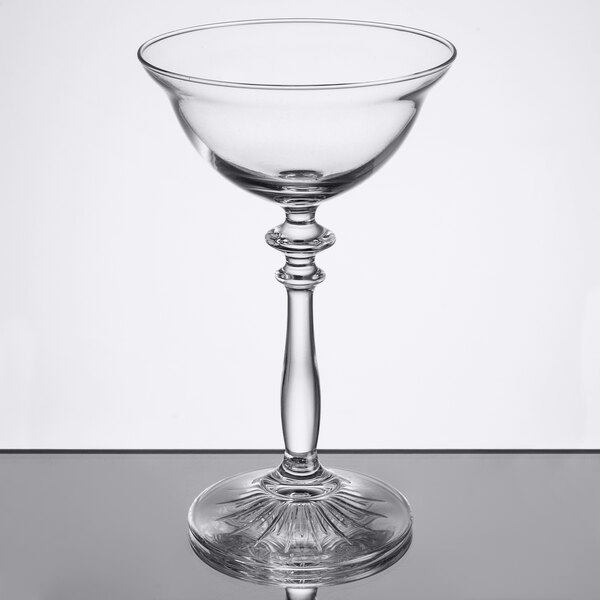 A clear glass Libbey Coupe Cocktail Glass with a long stem.