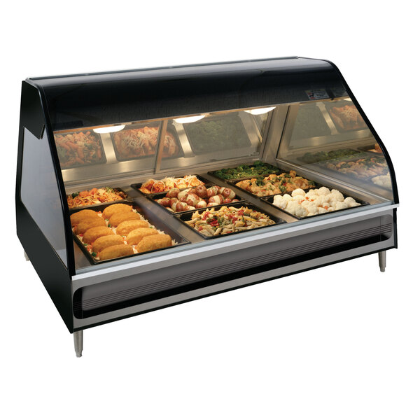 An Alto-Shaam stainless steel heated display case with food on trays.