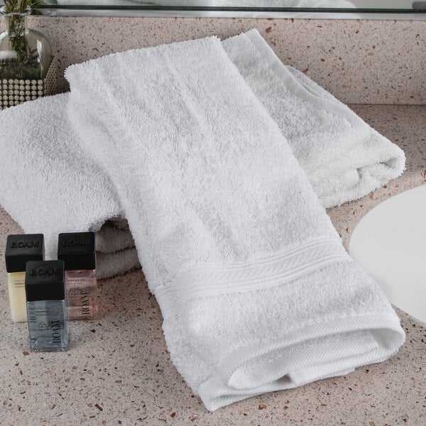 A white Oxford Vicenza hand towel on a white counter.