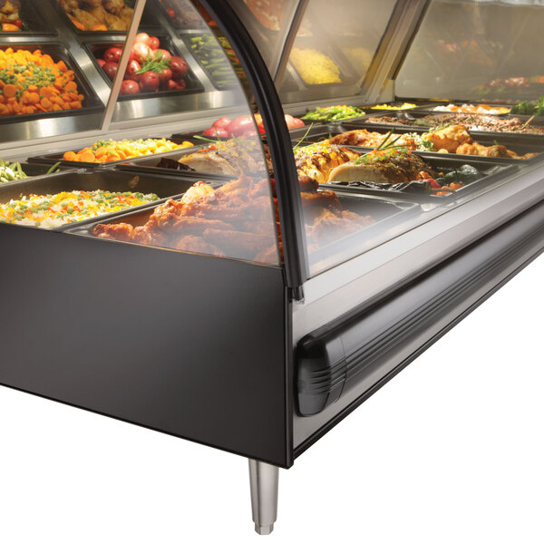 An Alto-Shaam 72" heated display case on a counter with food in it.