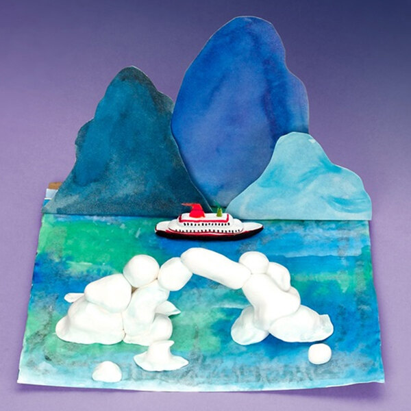 A white model of a ship on blue water made out of Crayola Model Magic.