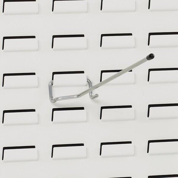 A metal hook on a white background in a white box.