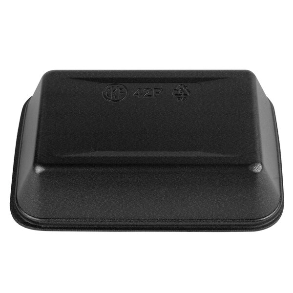 A black CKF foam meat tray with a clear plastic cover with text.