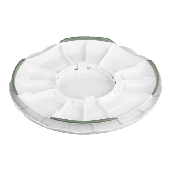 A white, round plastic turntable with segmented sections and green accents, designed for cake decorating.