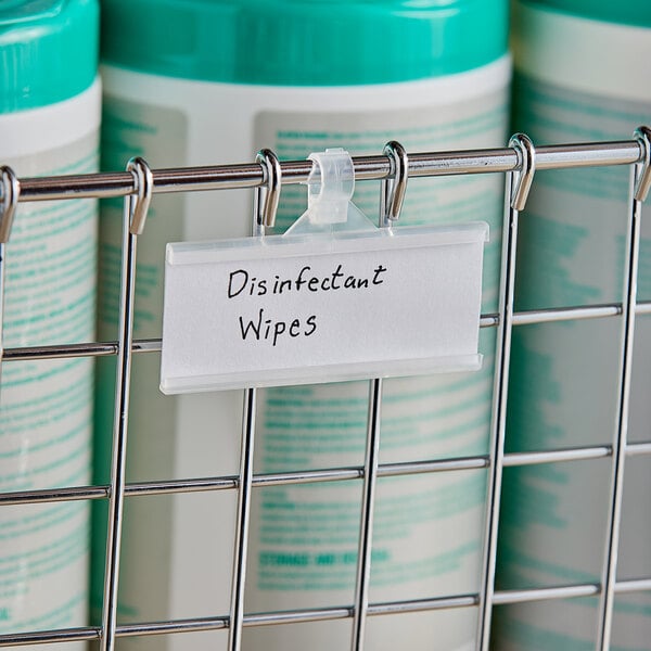 A Metro qwikSIGHT label holder attached to a metal rack with a label for disinfectant wipes.