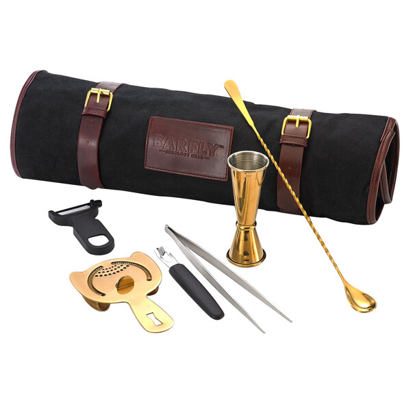 A Barfly gold-plated cocktail kit in a leather case on a table.