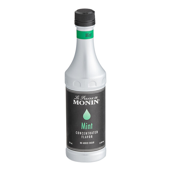 A white Monin bottle of mint flavored syrup with a black label.