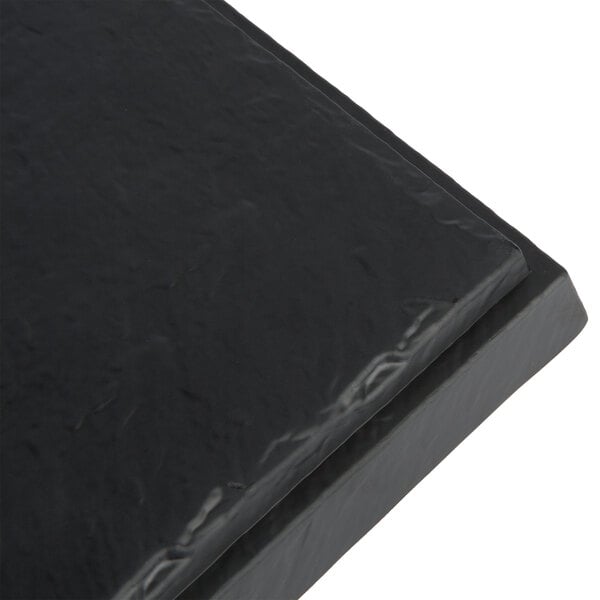 A black Tablecraft faux slate melamine display tray.