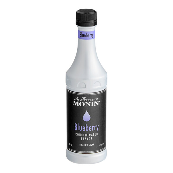 A white Monin bottle of Blueberry Concentrated Flavor with a black label.
