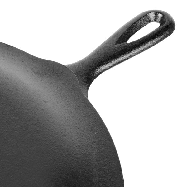 A close-up of a Lodge cast iron skillet with a handle.