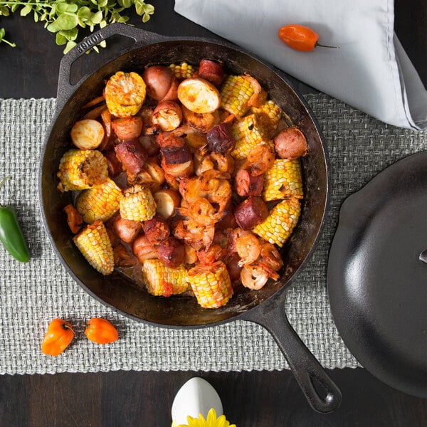 A Lodge cast iron skillet filled with food on a table.