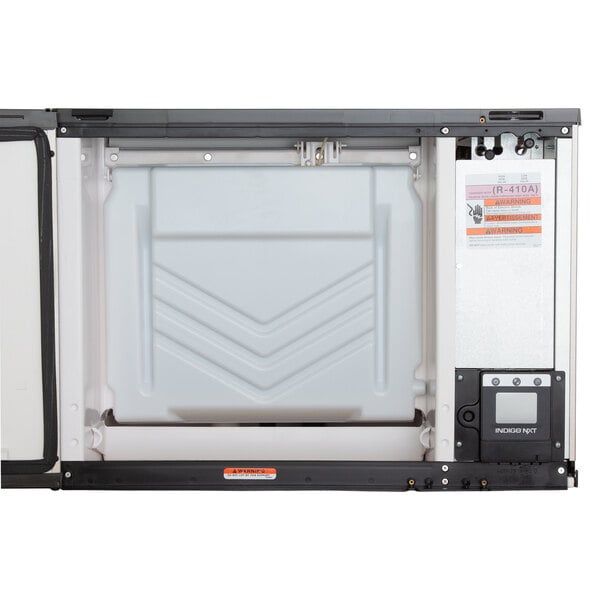 A white Manitowoc Indigo NXT water cooled ice machine on a white background.