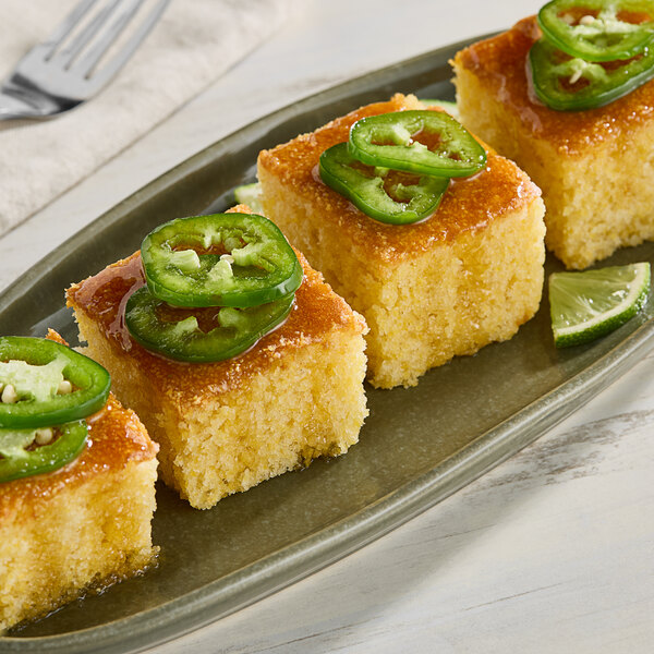 A plate of cornbread with Monin Jalapeno Concentrated Flavor on top.