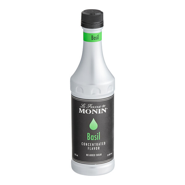 A white Monin bottle of Basil Concentrated Flavor with a black label.