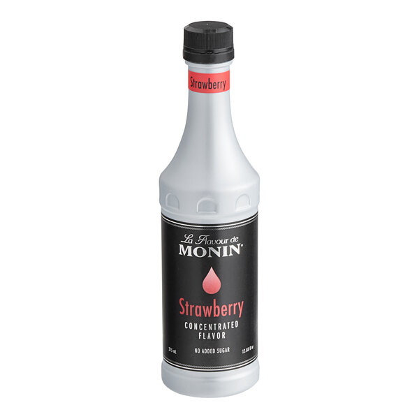 A white Monin bottle of strawberry concentrated flavor with a black label.