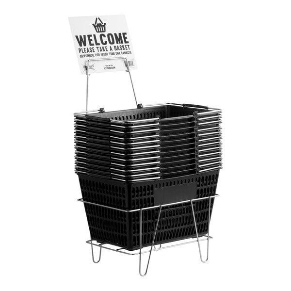 A set of black plastic grocery shopping baskets stacked on a metal stand with an attached welcome sign.