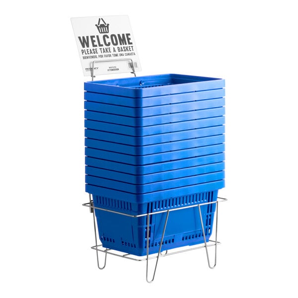 A stack of blue plastic grocery market shopping baskets with a metal stand and a welcome sign.