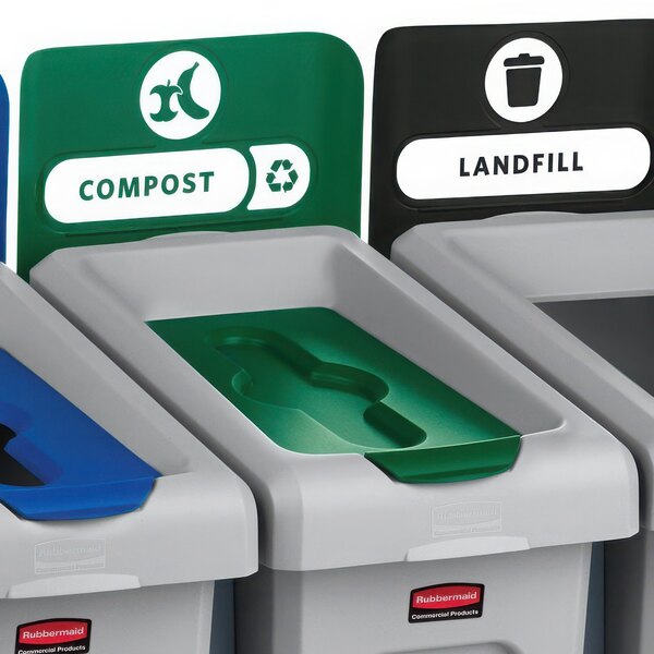 A close-up of a green and grey Rubbermaid Slim Jim recycling bin with a green lid.