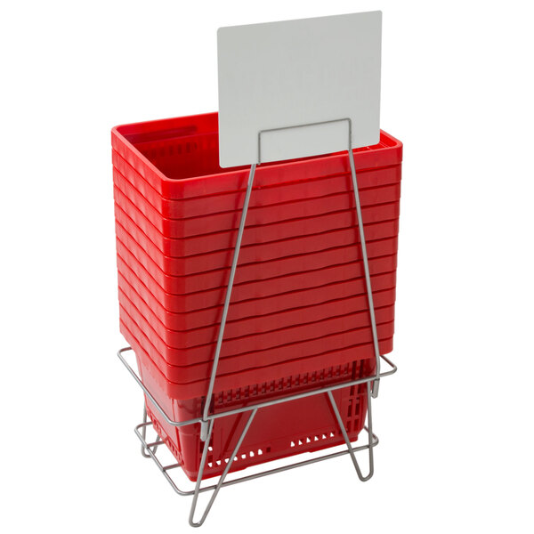 A stack of red plastic baskets with a white sign.