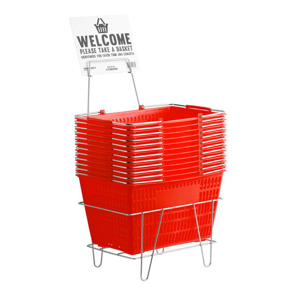A stack of red plastic grocery market shopping baskets with a metal stand and a welcome sign.