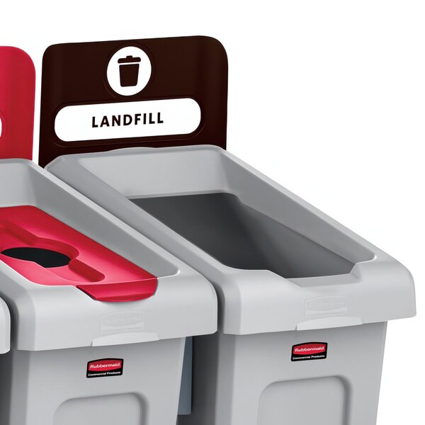 Three Rubbermaid Slim Jim recycling bins with brown labels for landfill.
