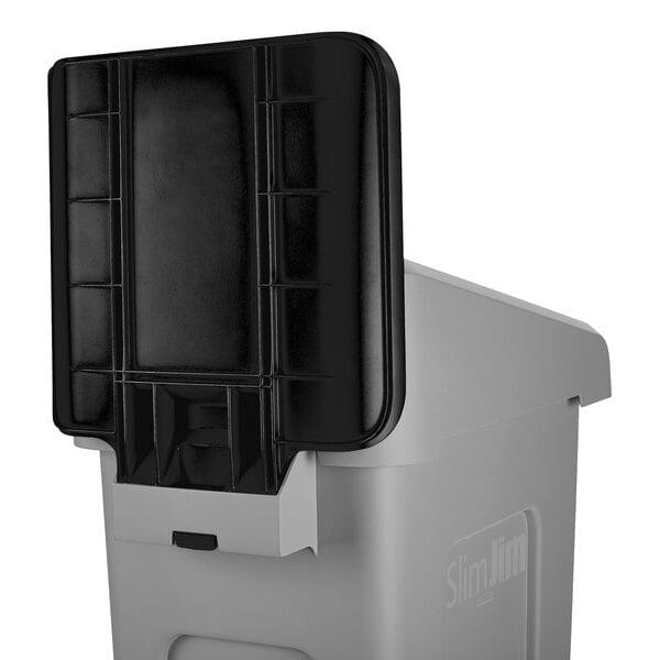 A grey and black plastic Rubbermaid Slim Jim recycling container.