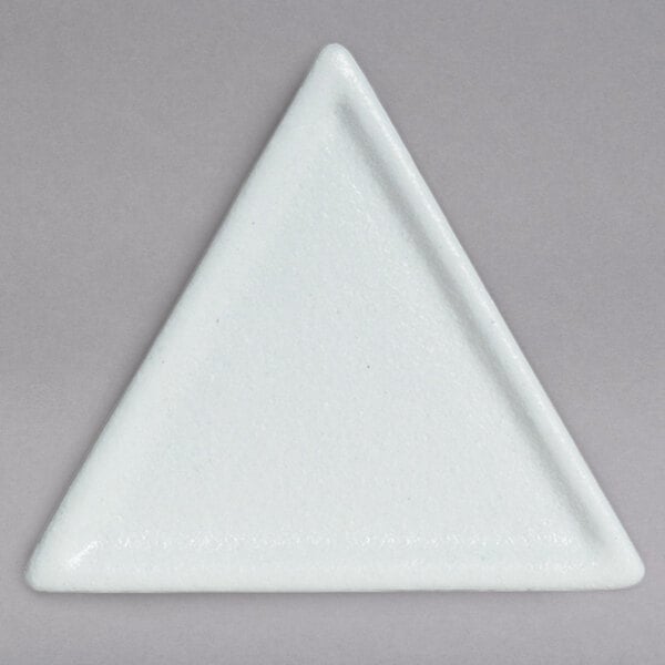 A white triangle shaped plate with a white triangle.