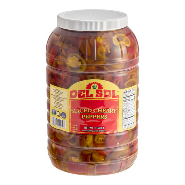 A large plastic jar of Del Sol sliced cherry peppers.