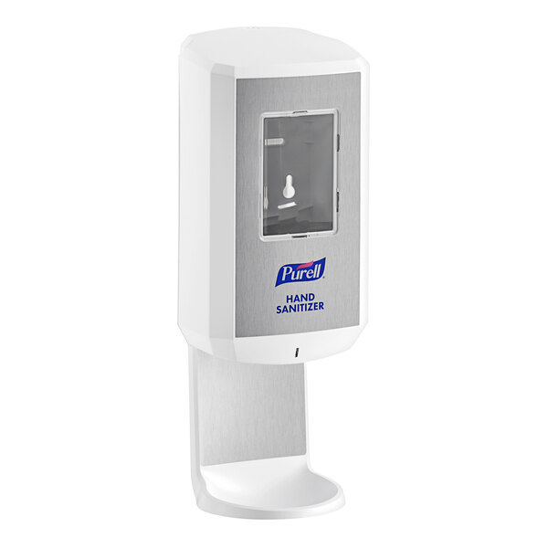 A white Purell hand sanitizer dispenser on a white wall.