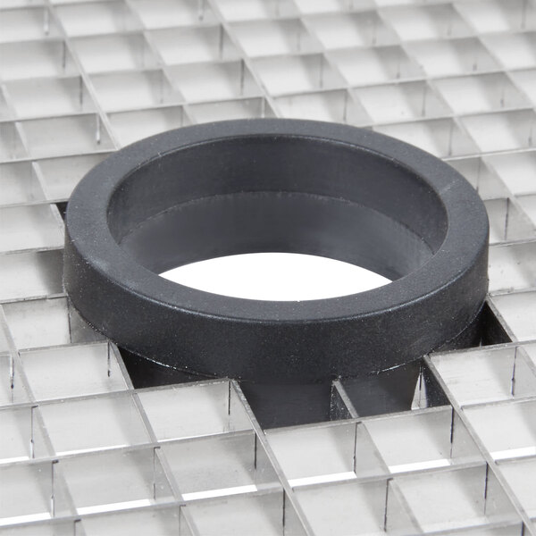 A black circle on a white surface with a white grid inside.