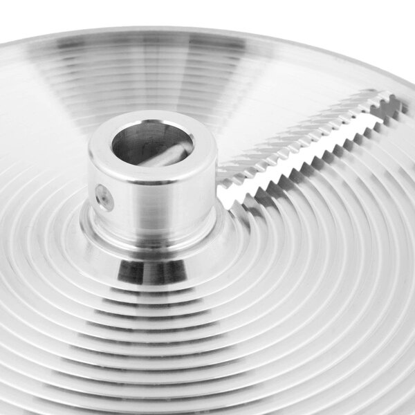 A close-up of a Berkel crimping plate, a circular metal object with a hole in it.