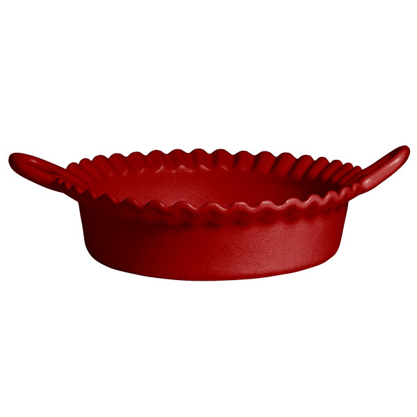 A red G.E.T. Enterprises Mexican cazuela with a wavy edge and handles.