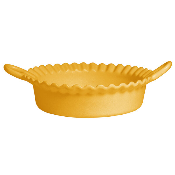 A yellow resin-coated aluminum deep Mexican cazuela with a handle.
