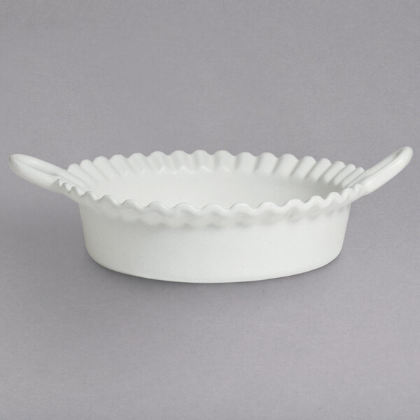 A white G.E.T. Enterprises deep Mexican cazuela bowl with a wavy edge.