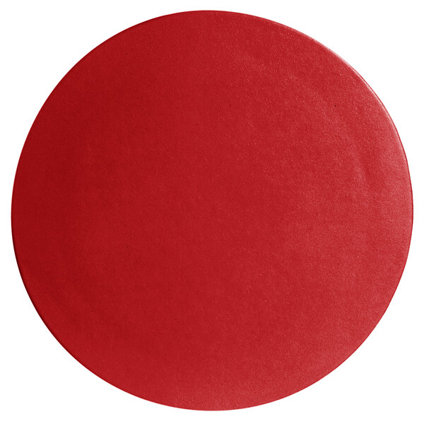 A cranberry red round disc with a textured surface.