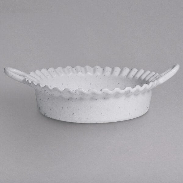 A white bowl with a scalloped edge.