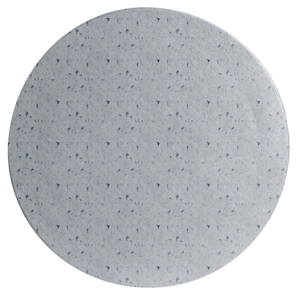 A white round metal disc with black specks.