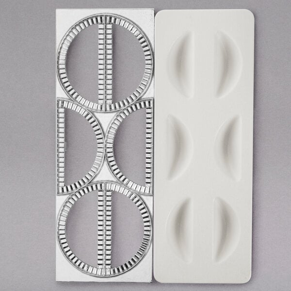 A white plastic Fox Run dumpling maker with circles cut out.